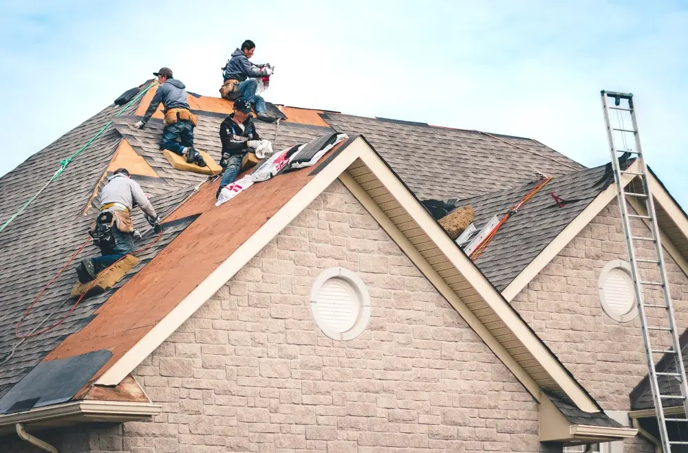Roofing contractor working on residential roof